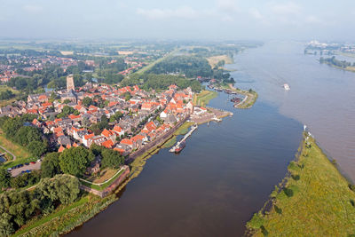 Aerial from the city woudrichem at the river merwede in the netherlands in a flooded landscape