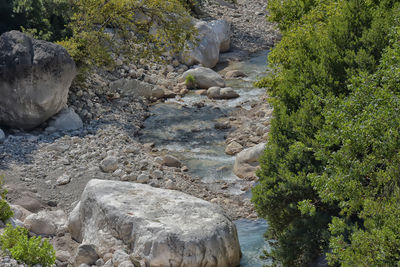 High angle view of stream amidst rocks