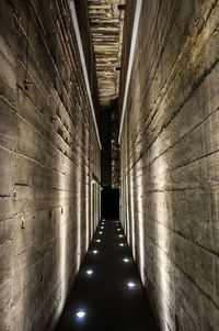 Empty narrow corridor along buildings