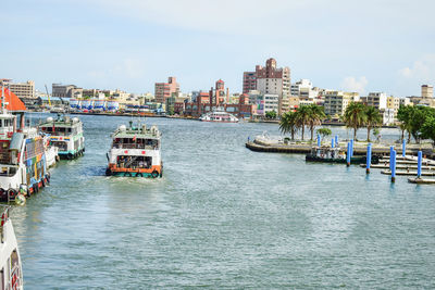 Buildings by sea against sky in city