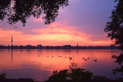 Scenic view of lake against orange sky