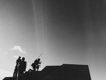 Low angle view of people against sky