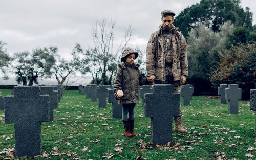 People standing on stone in cemetery