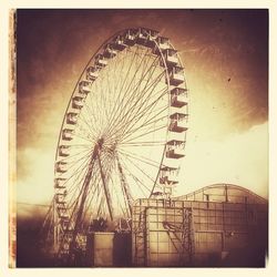 Low angle view of ferris wheel against sky