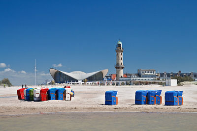 Lighthouse against blue sky at beach