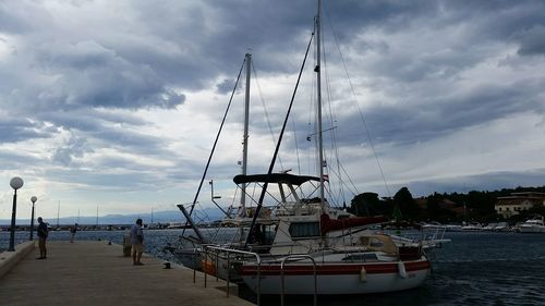 Ship moored in sea against sky