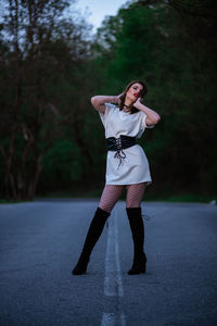 Full length portrait of young woman standing outdoors