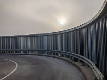 Empty road against sky during sunset