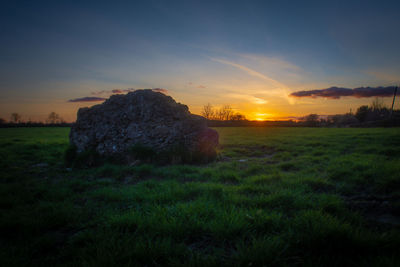 Scenic view of field against sky during sunset