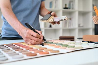 Midsection of man working on table