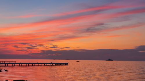 Scenic view of sea against orange sky