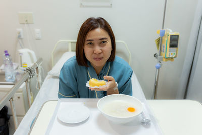 Portrait of woman holding food