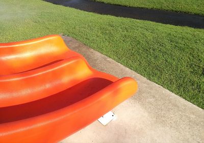 High angle view of red plastic bag on field