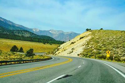 Country road leading towards mountains