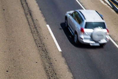 Blurred motion of car on road