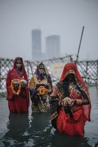 Midsection of women in water