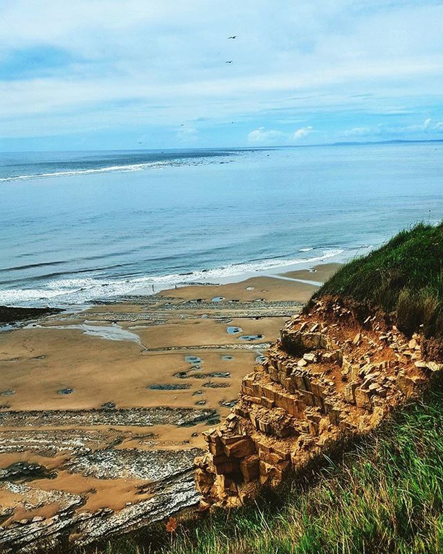 sea, beach, horizon over water, water, shore, sky, tranquil scene, sand, tranquility, scenics, beauty in nature, nature, coastline, cloud - sky, idyllic, grass, outdoors, day, remote, cloud