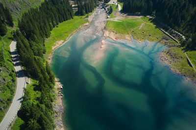 Aerial view of the branches of the lake of paneveggio trentino and bridge in the background