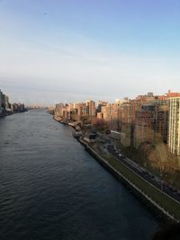 High angle view of river amidst buildings in city against sky