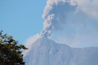 Low angle view of volcanic mountain against sky