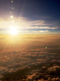Aerial view of clouds over landscape during sunset