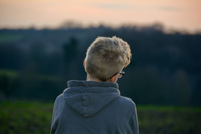 Boy from back looks in the nature