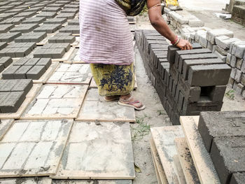 Low section of woman standing on cobblestone