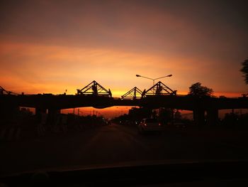 Silhouette of road against sky during sunset