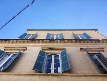 Low angle view of historic building against clear blue sky