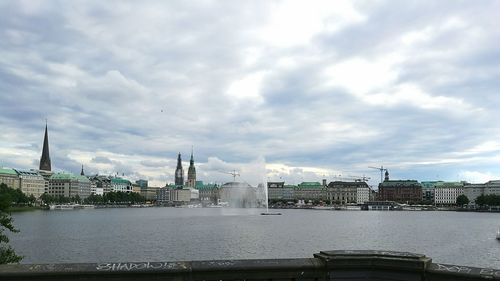 Cityscape against cloudy sky