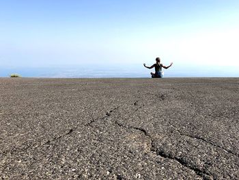 Full length of woman on beach against sky