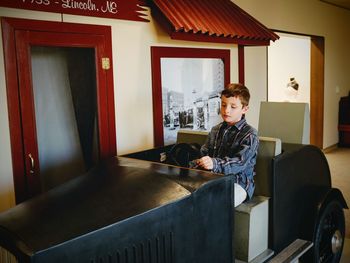 Portrait of boy sitting in room