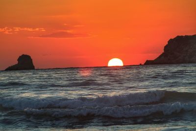 Scenic view of sea against orange sky