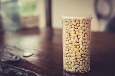 Pistachios in glass container on table