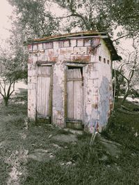 Abandoned house against trees