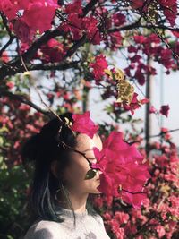 Close-up of woman with pink flowering plants