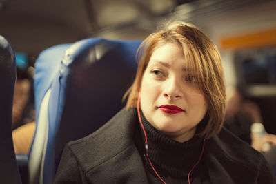 Close-up of young woman sitting in train