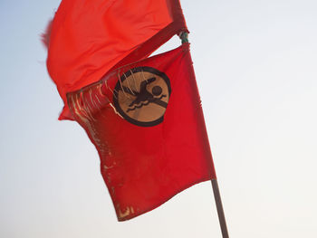 Low angle view of flag against clear sky