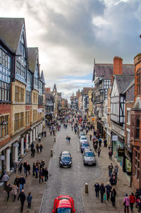 Crowd on city street against sky