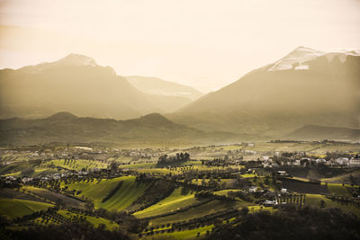 Scenic view of mountains against cloudy sky