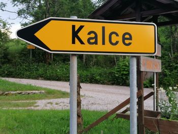 Road sign against trees