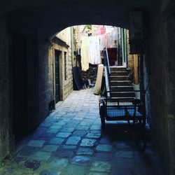 Empty alley amidst buildings in city