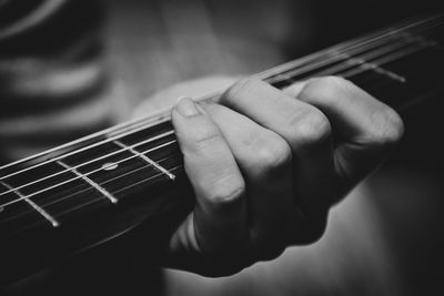 Close-up of hands playing guitar