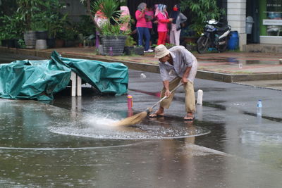 Side view of people working in water