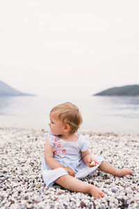 Full length of cute baby girl on beach