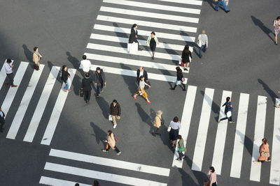 High angle view of people crossing road