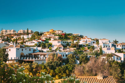 High angle view of townscape against clear blue sky