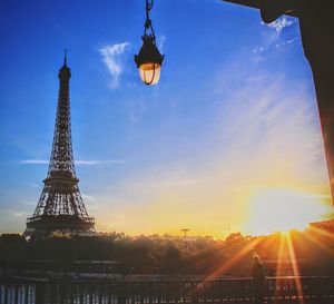 Communications tower in city during sunset