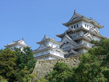 Osaka ,low angle view of building against clear blue sky