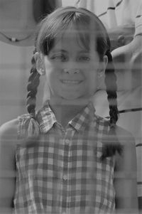 Portrait of smiling girl seen through net
